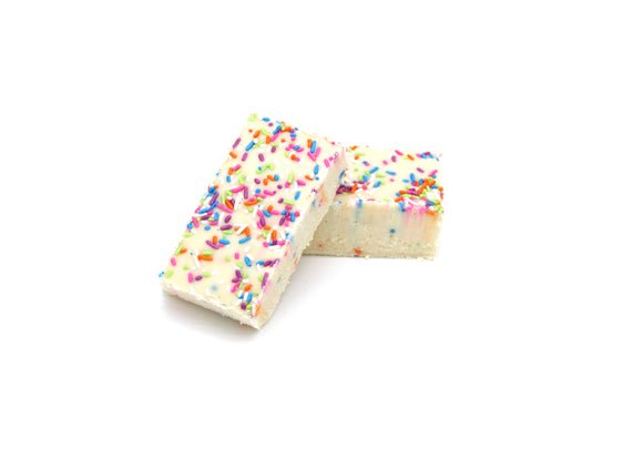 2 Pieces of Birthday Cake Fudge stacked on top of each other.  The Fudge is a creamy white topped with Birthday Sprinkles. 