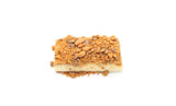 A single piece of Butterfinger Fudge.  The Fudge is a creamy white topped with crushed Butterfinger bits.
