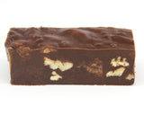A single piece of Chocolate Bourbon Pecan Fudge.  The Fudge is a rich chocolate color with pecans mixed into it.